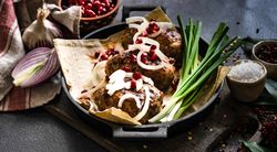 Meal of  abkhazura cutlets served with pomegranate seeds & onions