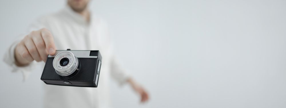 Retro camera floating in hand