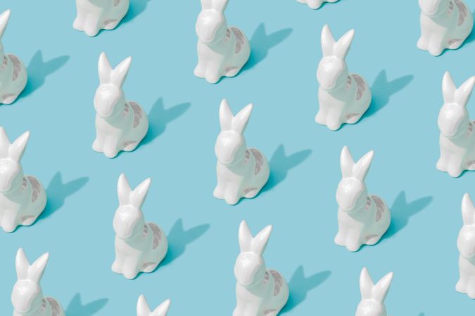 Pattern composition of Easter bunnies on pastel blue background