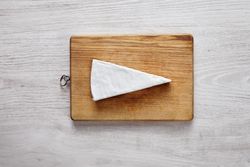 Large chunk of light cheese on wooden board