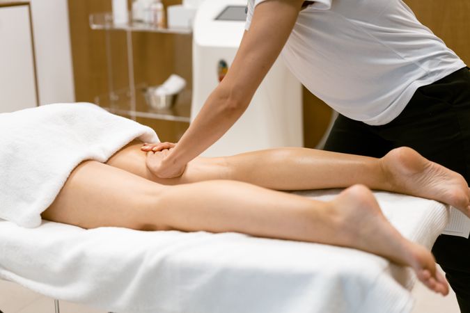 A female’s legs being massaged in a salon