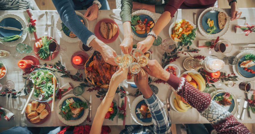 Top Down View on People Raising Champagne Glasses and Toasting, Celebrating a Holiday Together