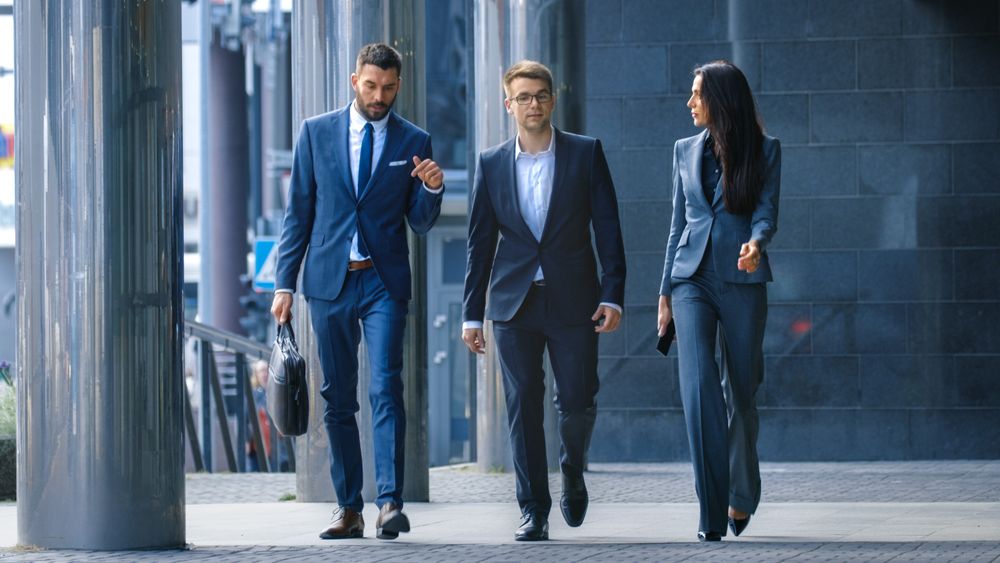 Male and Female Business People Walk and Discuss Business.