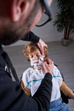 Boy shaving in a barbershop