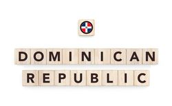 Wooden blocks bearing the name and flag of Dominican Republic. Dominican and Caribbean Culture, national identity, travel, and geography in a copy space design.