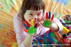 Happy young girl playing with finger paints 4ApER5