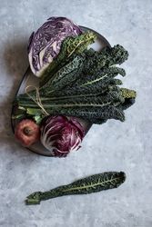 Pomegranate near red cabbage and kale