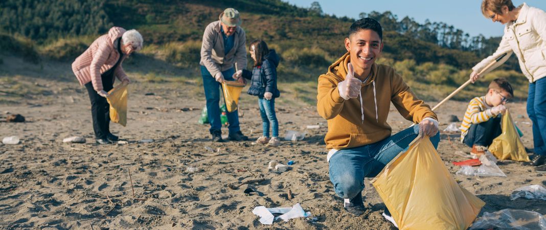 Young man cleaning the beach