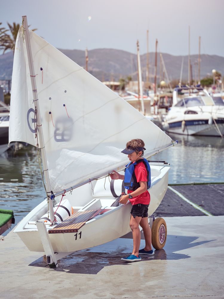Boy preparing boat for sailing
