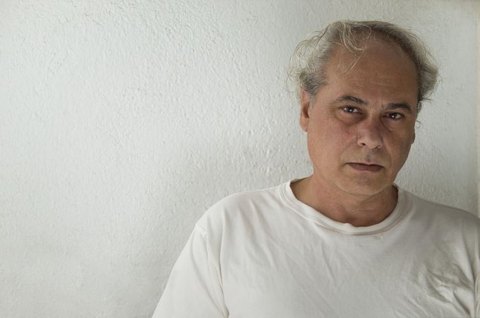 Portrait of upset middle aged man in light shirt