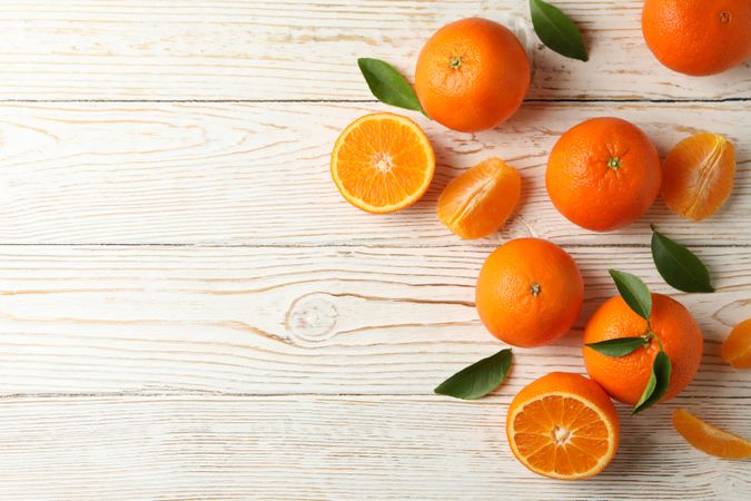 Ripe sweet mandarins on wooden background, top view