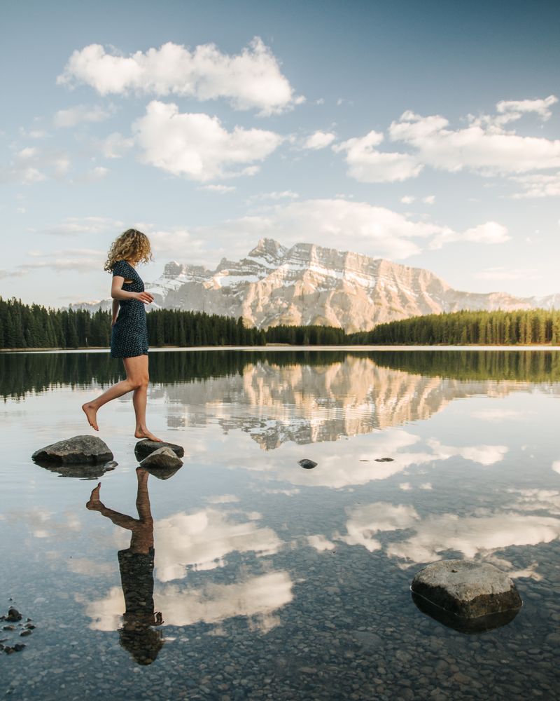 Woman standing on rock above lake