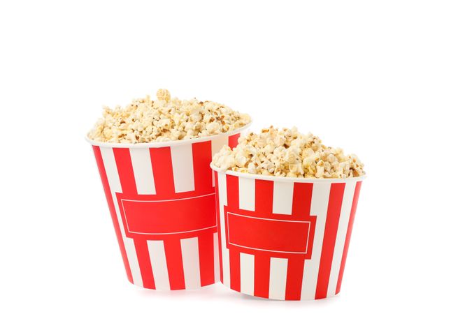 Striped buckets with popcorn isolated on plain background