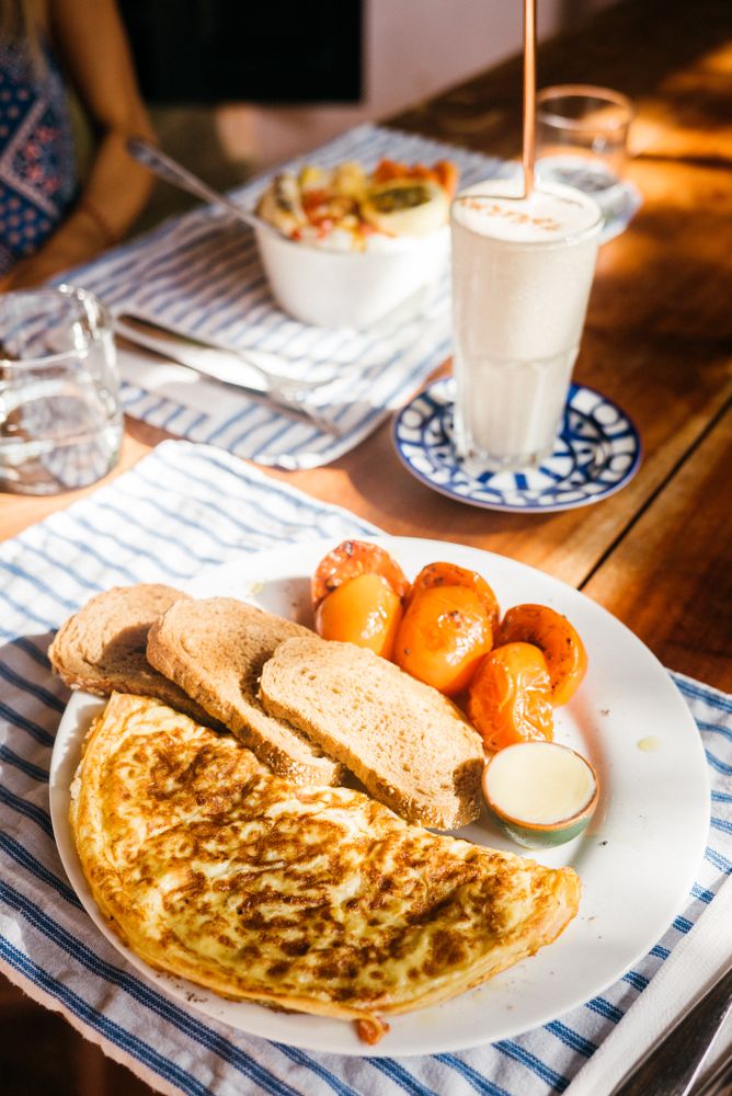 Table set with omelette breakfast and yogurt drink