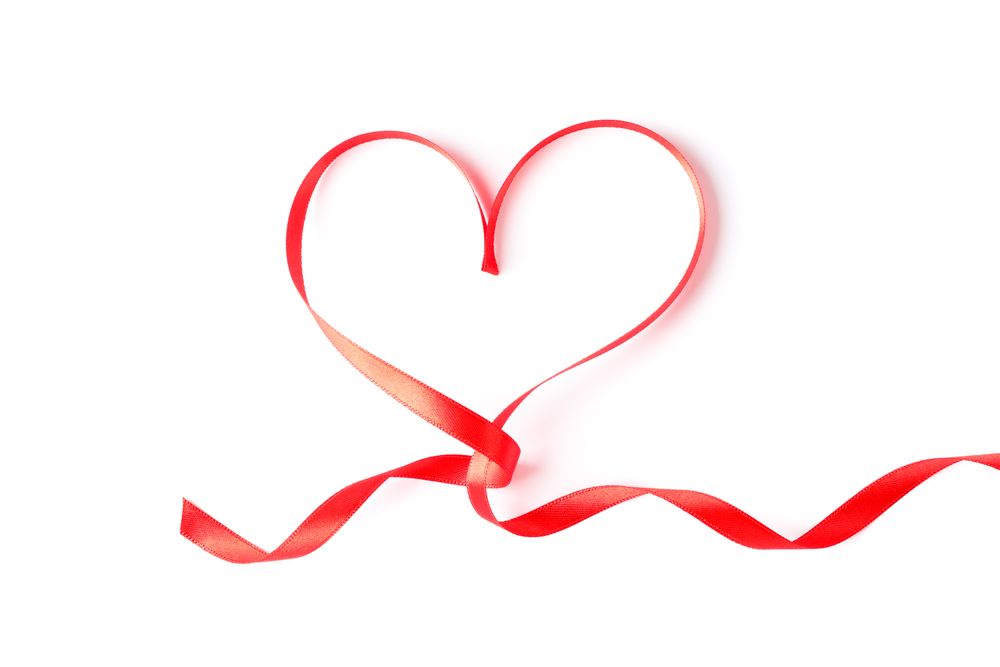 Red ribbon heart isolated on blank background