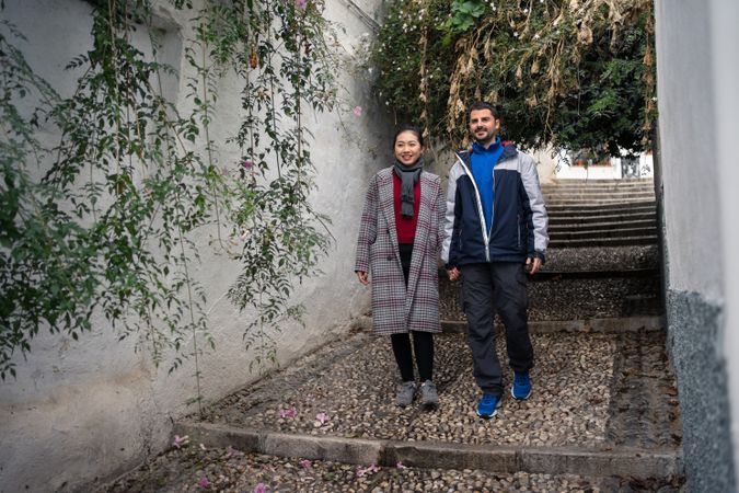 Pleased diverse couple exploring ancient town together