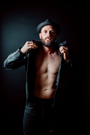 Young shirtless bearded guy in leather jacket