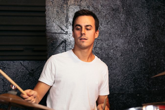 Close-up of a musician playing the drums in a music rehearsal room