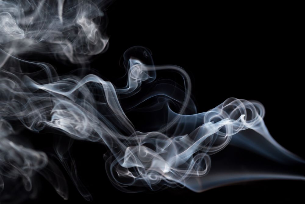Abstract smoke moving on dark background