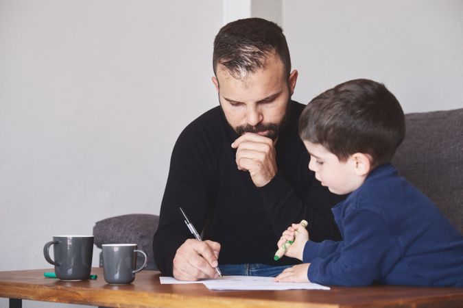 Father and son drawing together