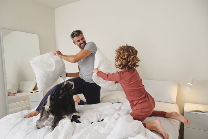 Happy father and son playing with dog