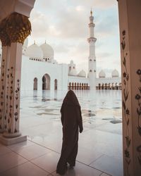 Anonymous muslim woman on square of beautiful mosque