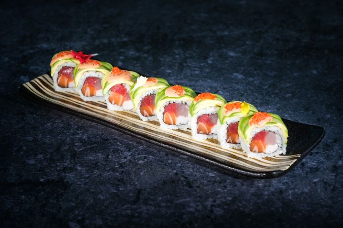 Delicious sushi rolls with avocado slices