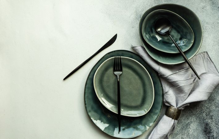 Top view of full table setting on grey background