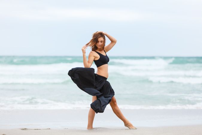 woman dancing near sea