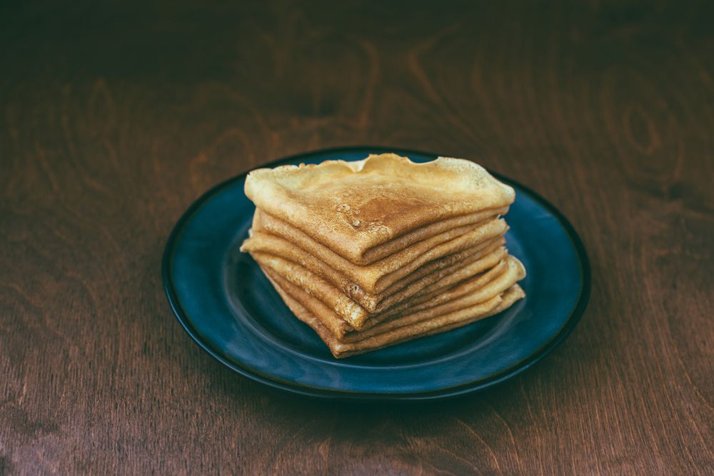 Sauce near stack of blini