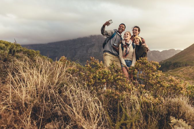Young group of people taking selfie on hike