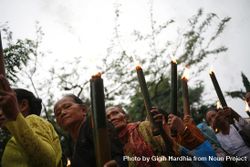 Group of older Indonesian Hindu women with torches with lit flames marching during Nyepi day 5pagw4