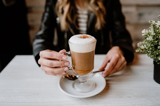 Woman drinking coffee from a glass