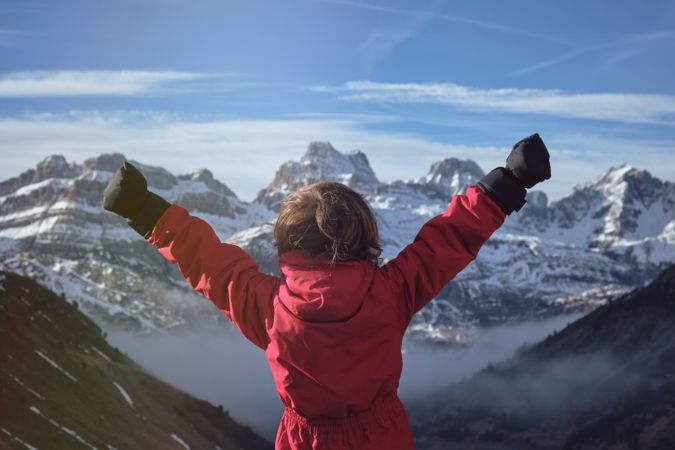 Anonymous kid celebrating success in mountains