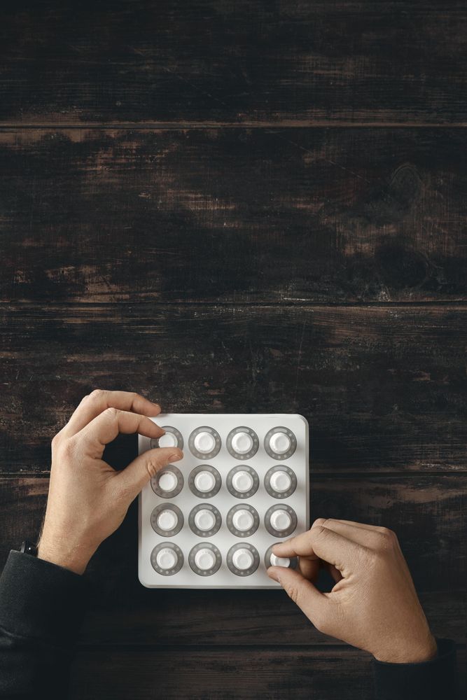 Top view two hands twisting knobs on wireless midi mixer control