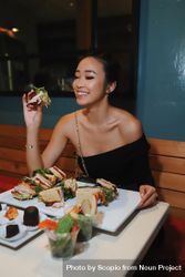 Woman about to eat club sandwich at a restaurant 0Pmz25