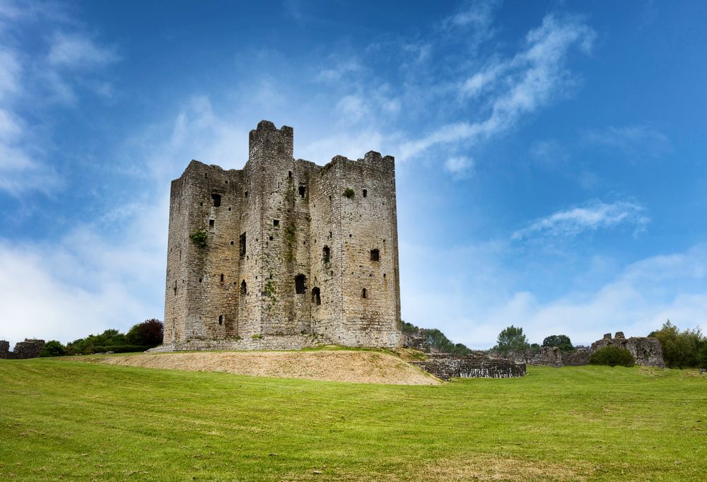 Ancient mediaeval castle in Ireland surrounded by grassy fields