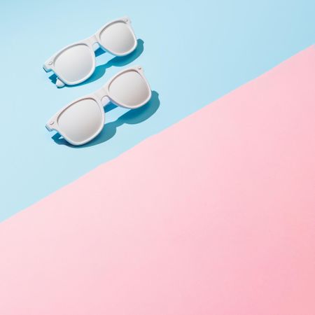 Painted sunglasses with pastel pink and blue background