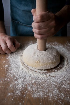 Crop man preparing Rosca de Reyes