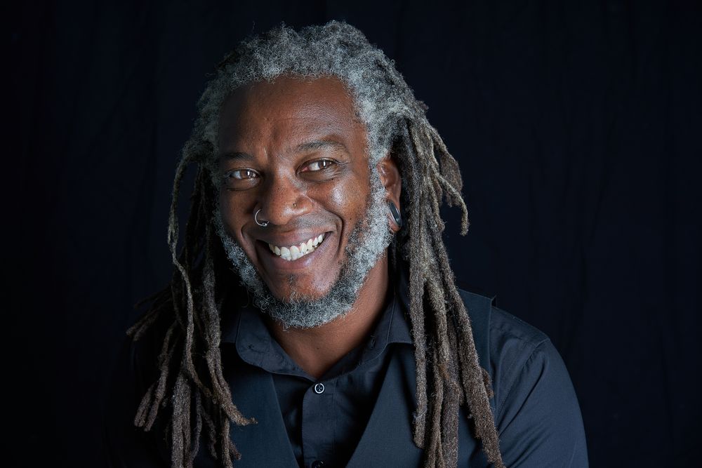Man with dreads smiling