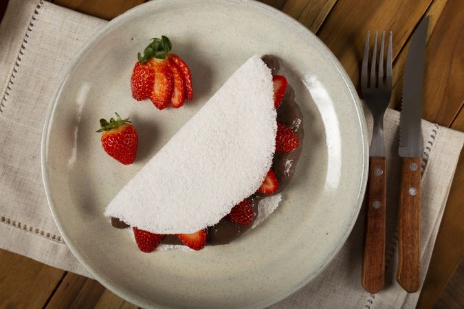 Sweet tapioca stuffed with chocolate and strawberry. Brazilian tapioca.