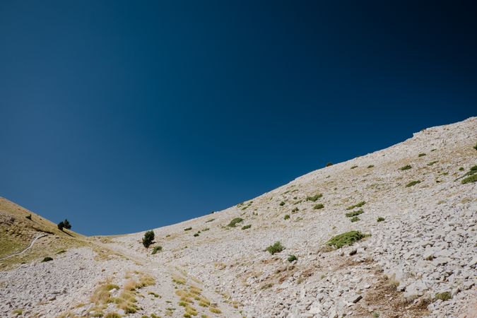 Landscape with hill and moon in blue sky