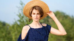 Young woman in straw hat outdoors