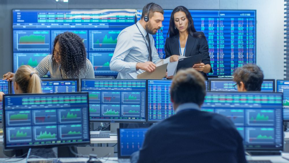 Multi-Ethnic Team of Traders is Busy Working at the Stock Exchange Office.