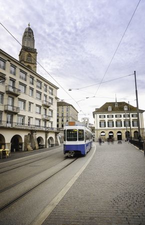 Zurich cityscape with blue tram in the old city center