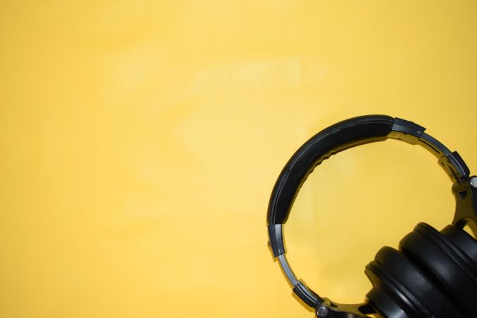 Headphones in corner of yellow background