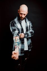 Young bald guy showing tattoos