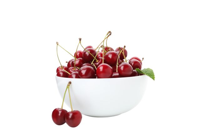 ripe cherry fruits in a bowl, isolated on blank background