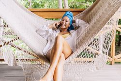Woman in turban resting in hammock