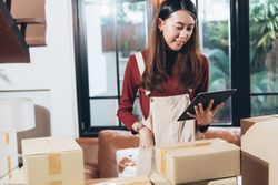 E-commerce business owner checking orders on her tablet